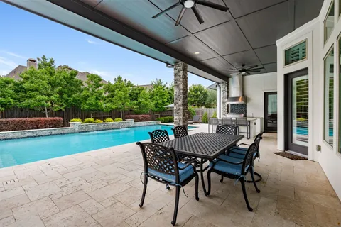 a view of a patio with a table chairs and a yard
