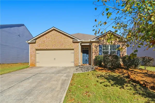a front view of a house with a yard