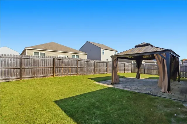 a view of a house with a yard and sitting area