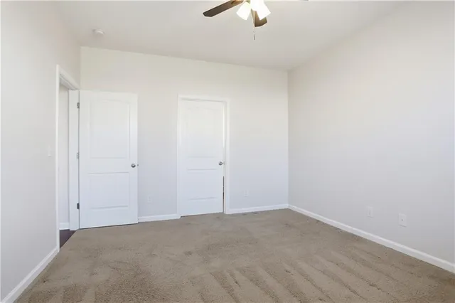 an empty room with a empty space and a ceiling fan