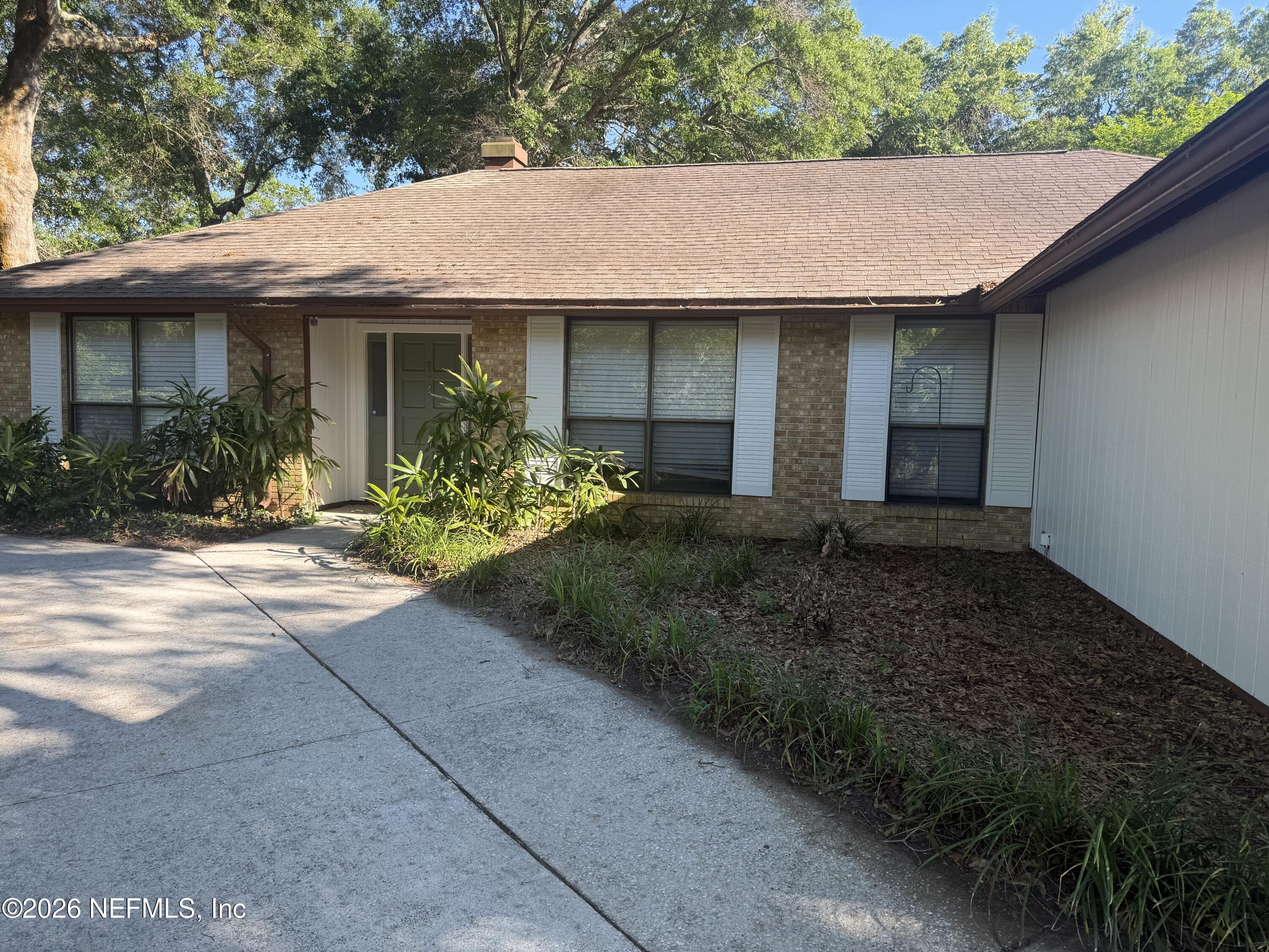 11238 McCormick Road Jacksonville, FL 32225 - Photo 2 of 25 a front view of a house with garden