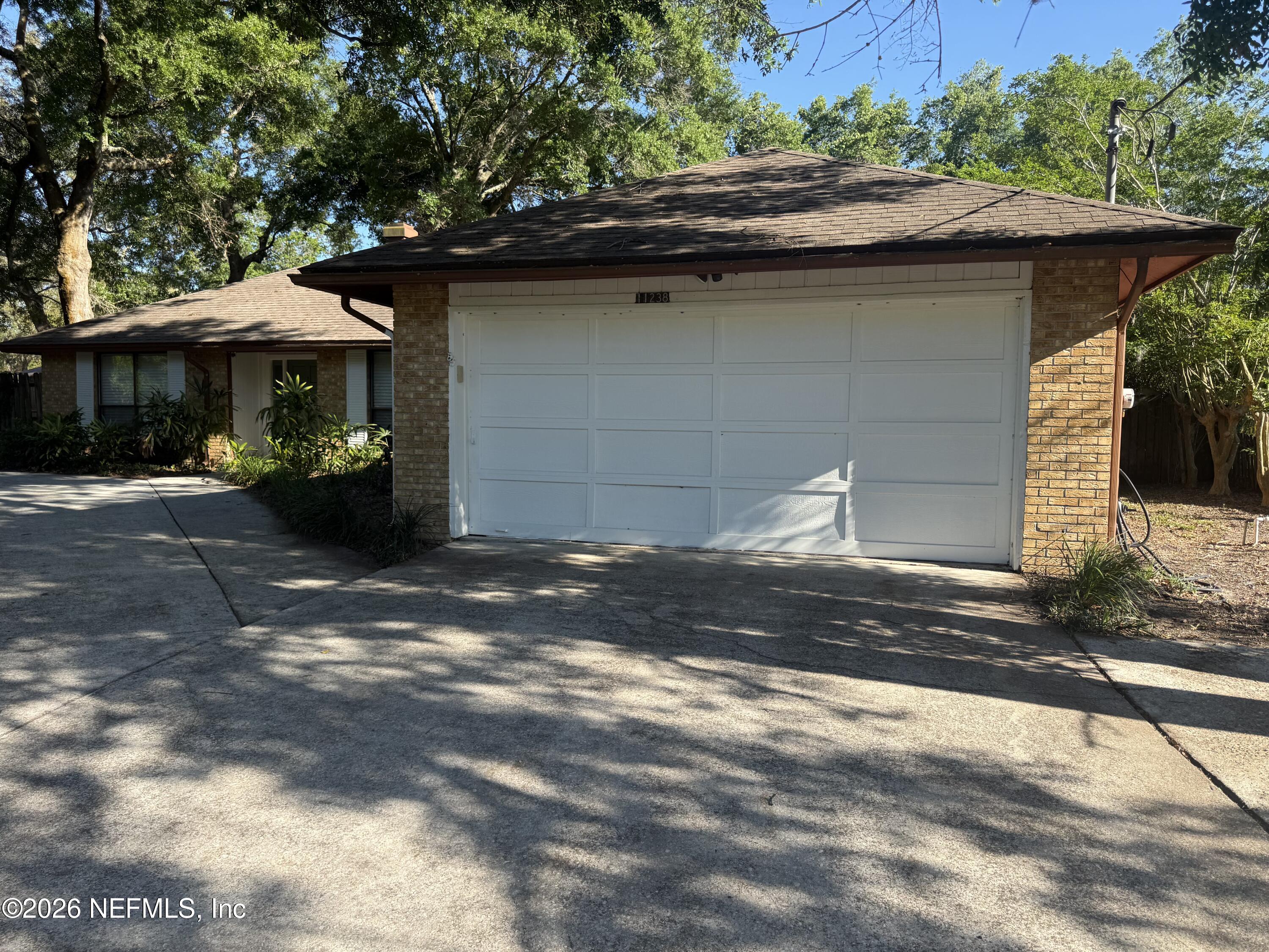 11238 McCormick Road Jacksonville, FL 32225 - Photo 3 of 25 a front view of a house with garden