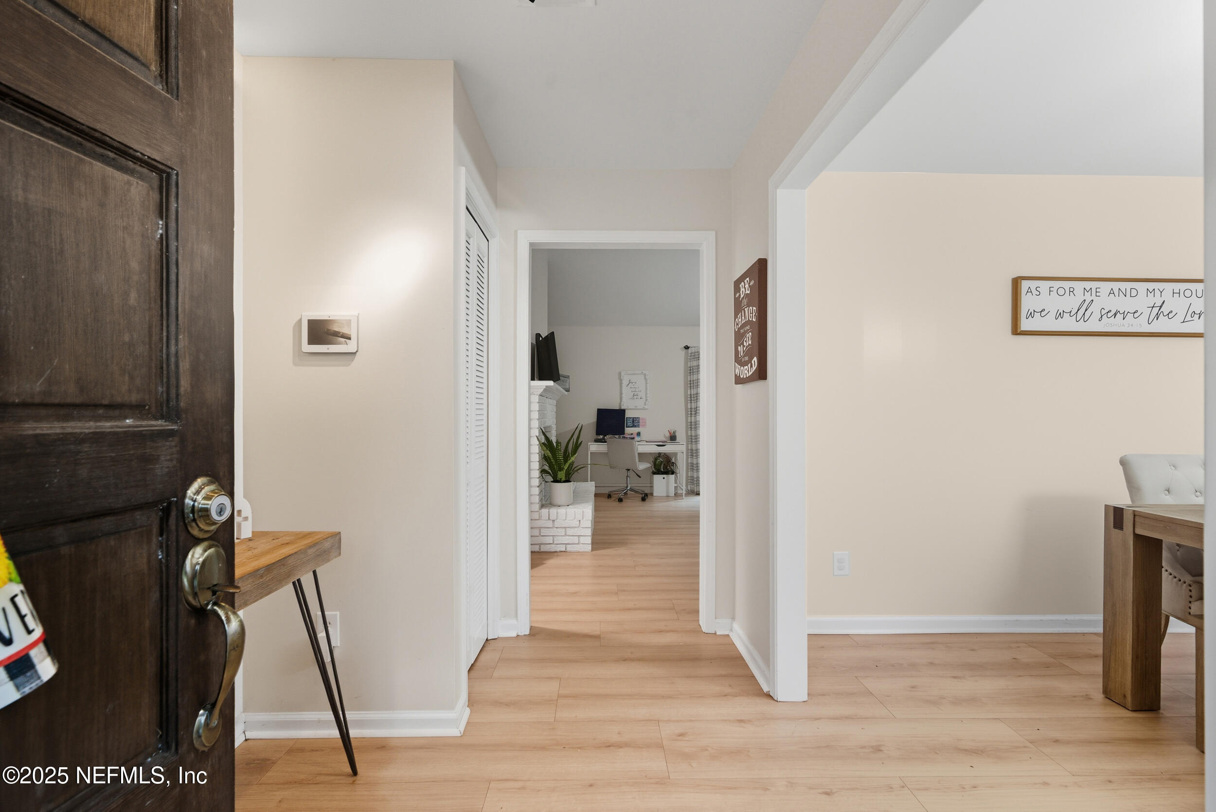 11238 McCormick Road Jacksonville, FL 32225 - Photo 5 of 25 a view of a hallway with wooden floor and a living room