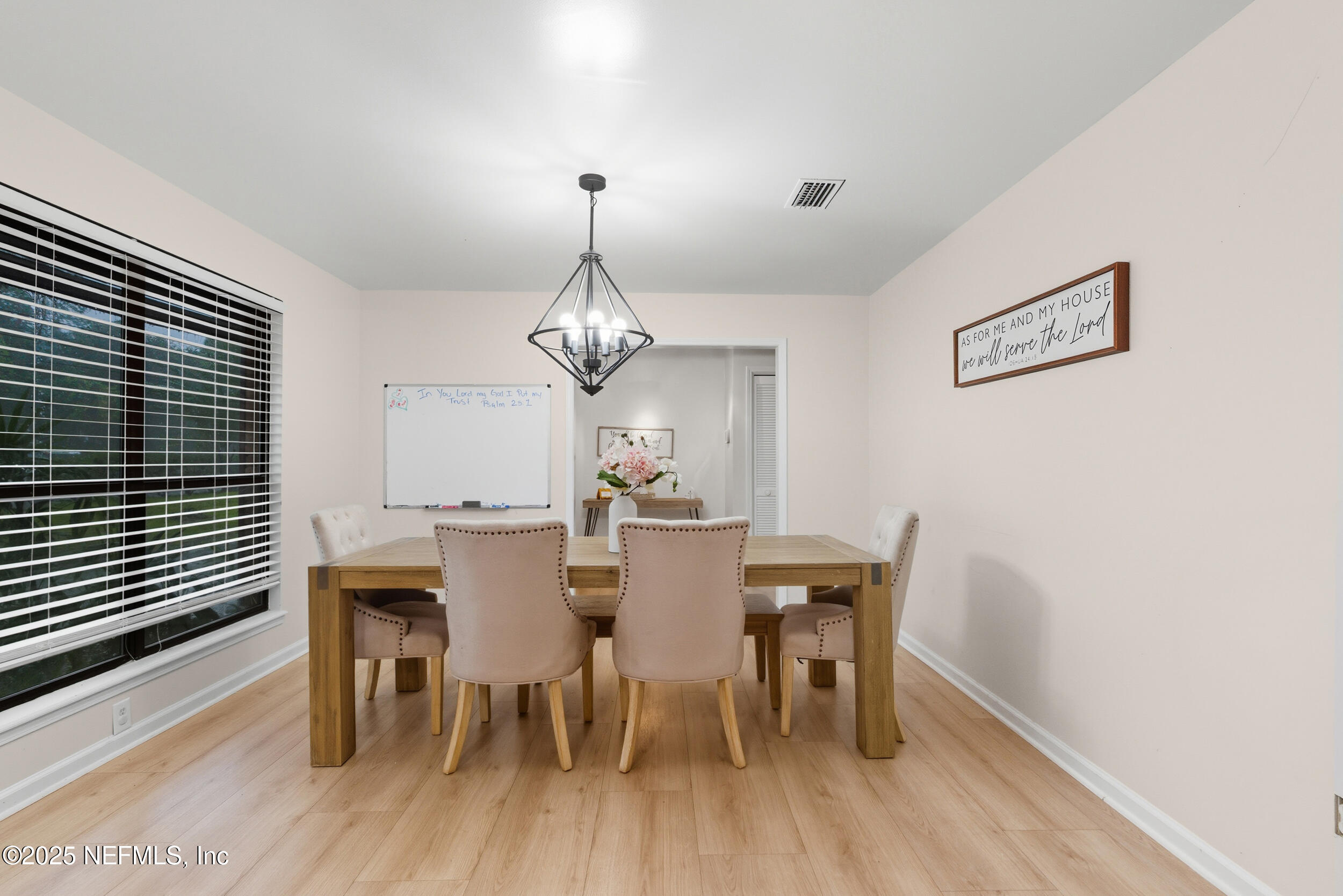11238 McCormick Road Jacksonville, FL 32225 - Photo 7 of 25 a view of a dining room with furniture wooden floor and chandelier