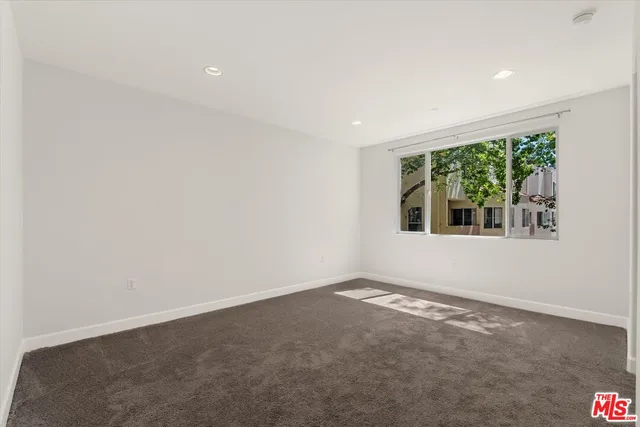 an empty room with large windows