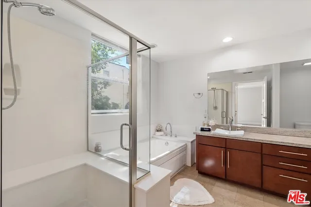 a bathroom with a tub sink and mirror
