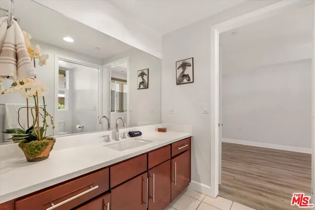 a bathroom with a sink a mirror and a shower