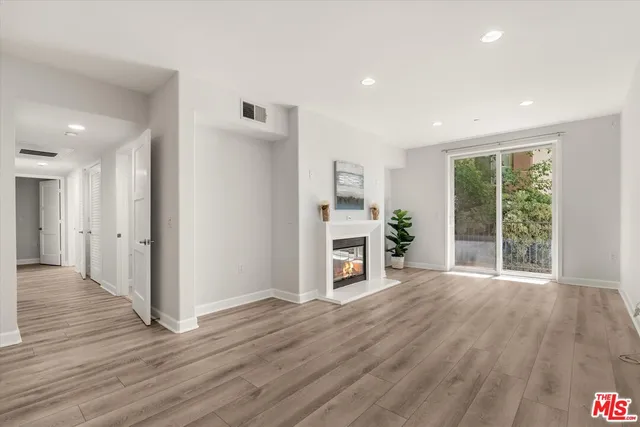 a view of a livingroom with furniture wooden floor and window