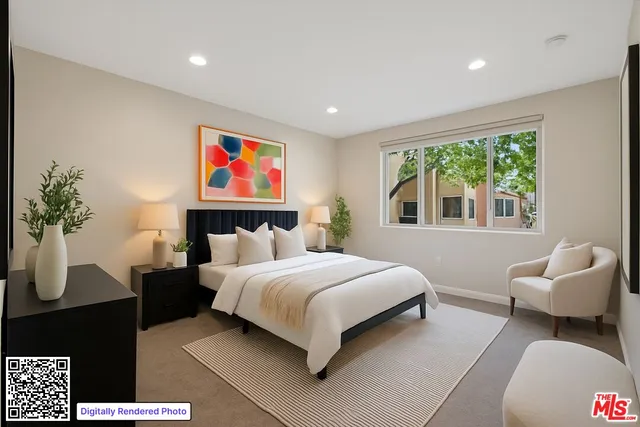 a bedroom with a large bed and a potted plant