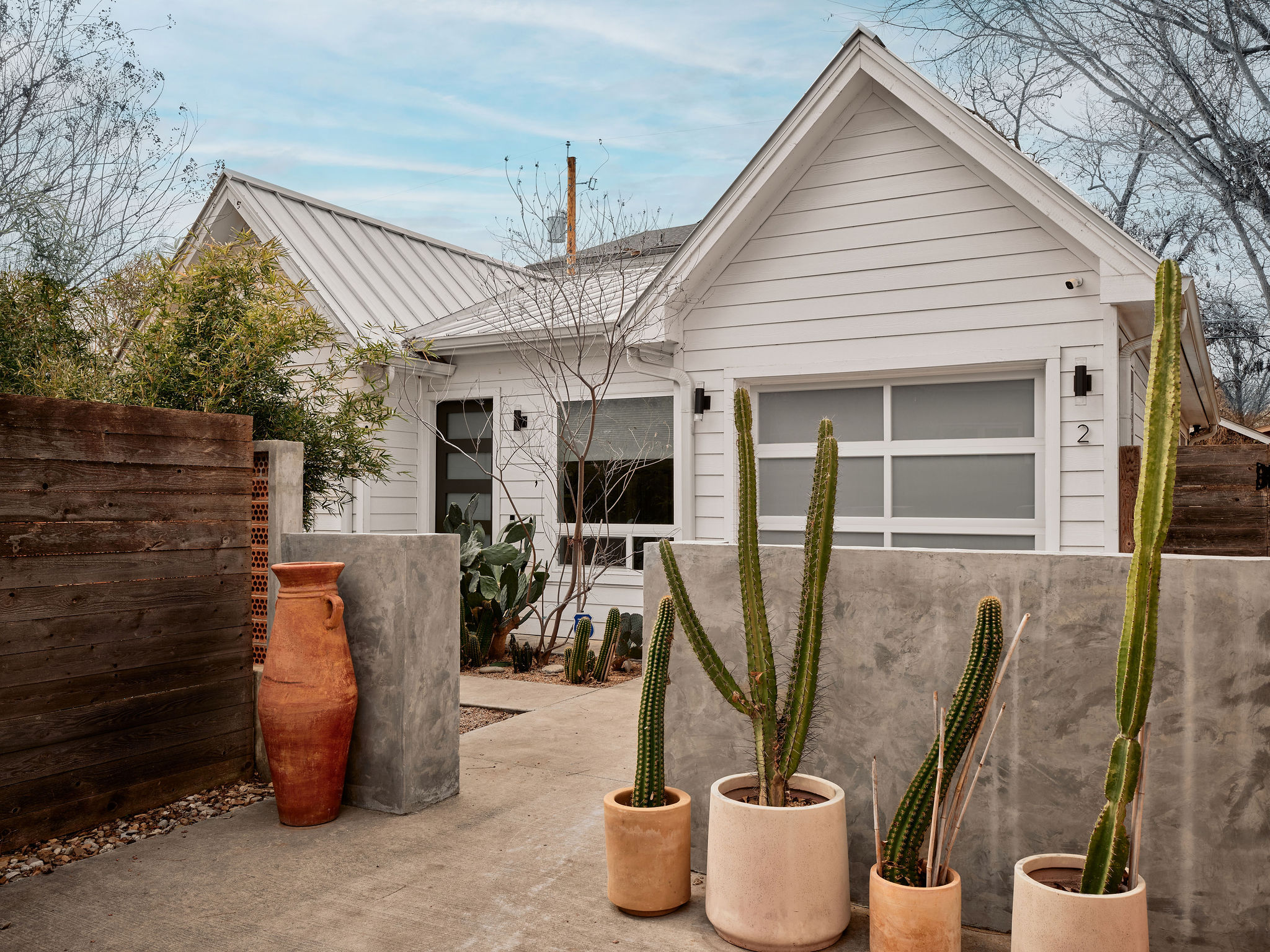 a view of a patio with table and chairs potted plants