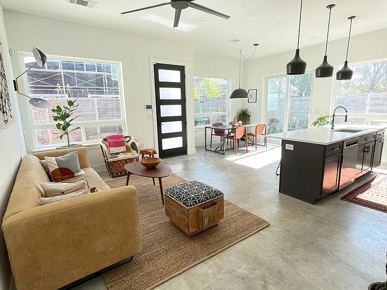 910 Gullett Street, Unit 2 Austin, TX 78702 - Photo 3 of 19 Living area featuring healthy amount of natural light, a ceiling fan, and finished concrete floors