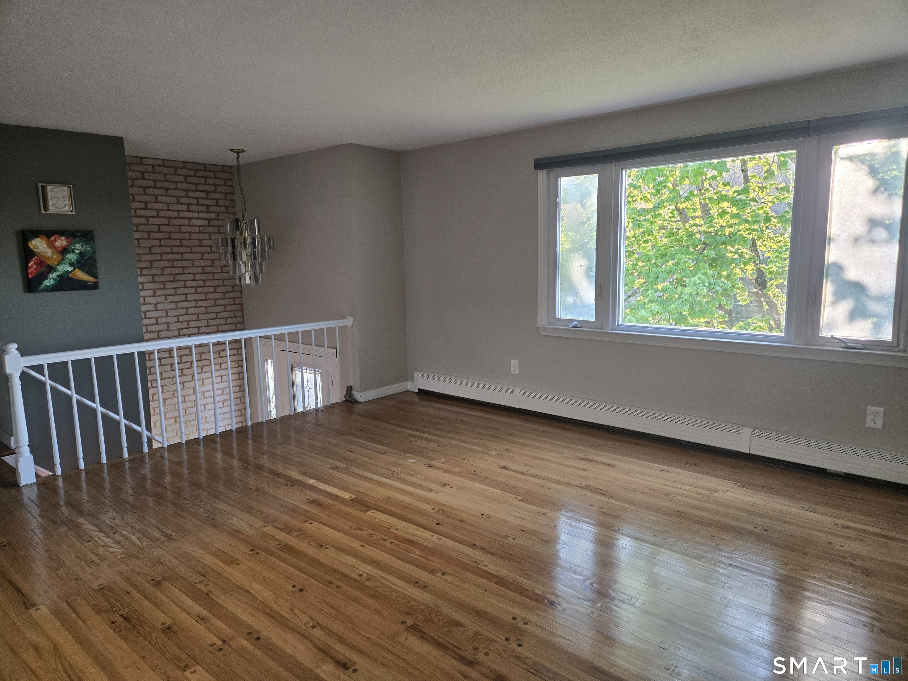 1004 Hickory Hill Road Thomaston, CT 06787 - Photo 18 of 23 a view of an empty room with wooden floor and a window