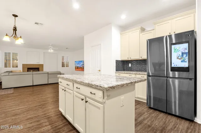 a kitchen with granite countertop a stove a sink and a microwave