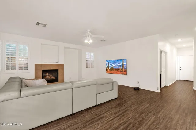 a kitchen with white cabinets and window