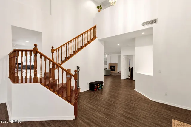 a view of hallway with stairs and wooden floor
