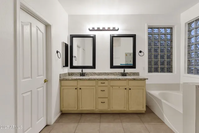 a spacious bedroom with a bed and wooden floor