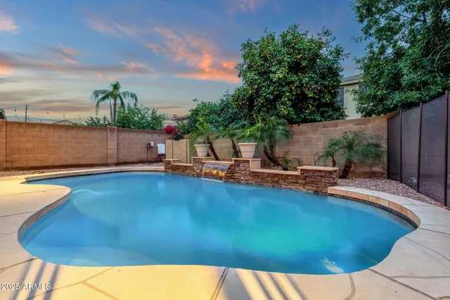 a view of a backyard with swimming pool