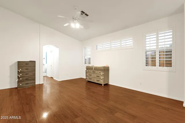 a view of a livingroom with furniture and a ceiling fan
