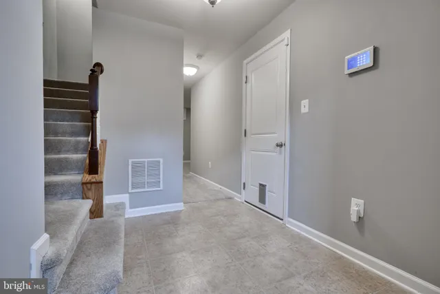 a view of an empty room with a cabinet