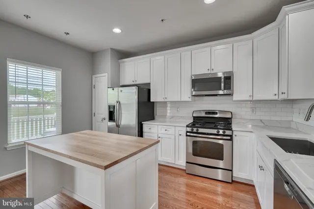 a view of room with window and wooden floor