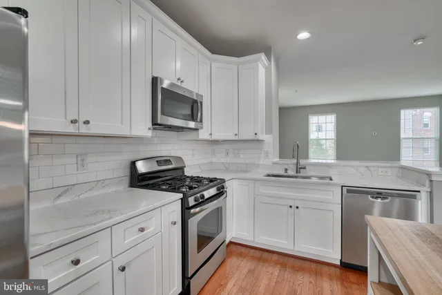 a bathroom with a sink mirror and toilet