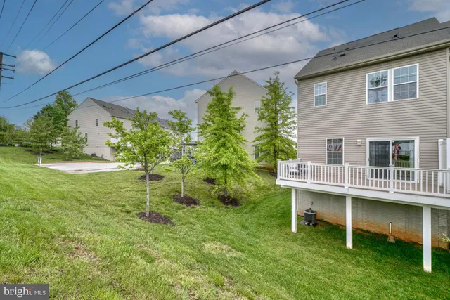 a backyard of a house with a yard and outdoor seating