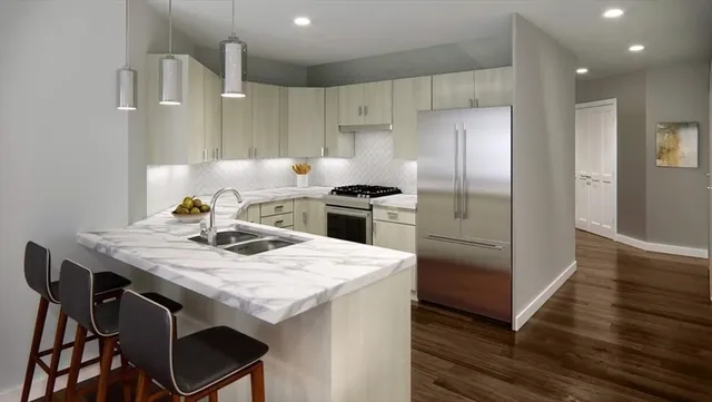 a kitchen with a table chairs refrigerator and microwave
