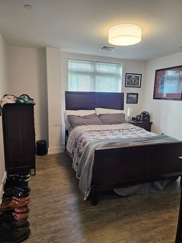 a bedroom with a bed and a television