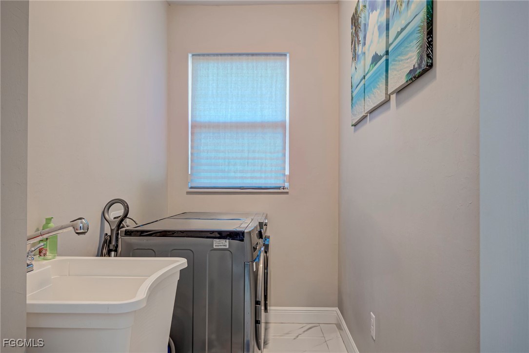 3309 30th Street Southwest Lehigh Acres, FL 33976 - Photo 14 of 28 a bathroom with a sink and a toilet