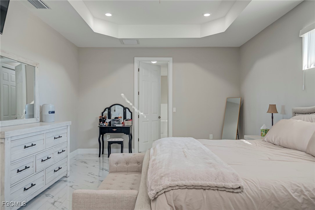 3309 30th Street Southwest Lehigh Acres, FL 33976 - Photo 15 of 28 a bedroom with a bed and a dresser