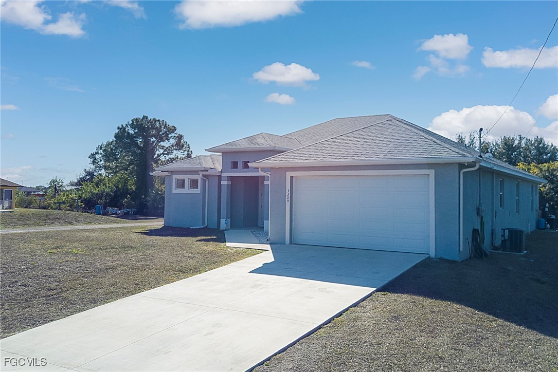 3309 30th Street Southwest Lehigh Acres, FL 33976 - Photo 21 of 28 a view of a house with a yard