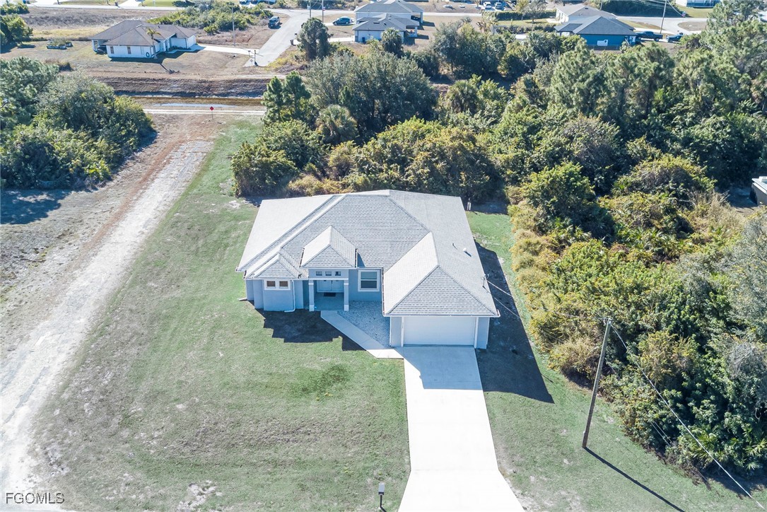 3309 30th Street Southwest Lehigh Acres, FL 33976 - Photo 24 of 28 an aerial view of a house with a yard