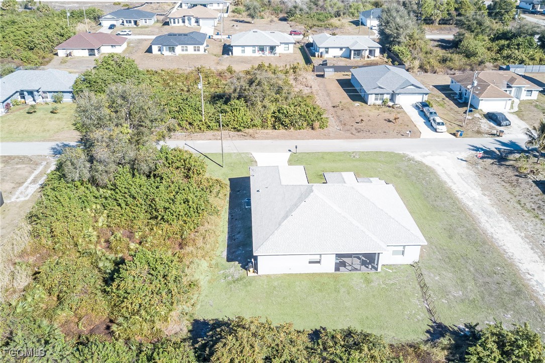 3309 30th Street Southwest Lehigh Acres, FL 33976 - Photo 27 of 28 an aerial view of residential houses with outdoor space
