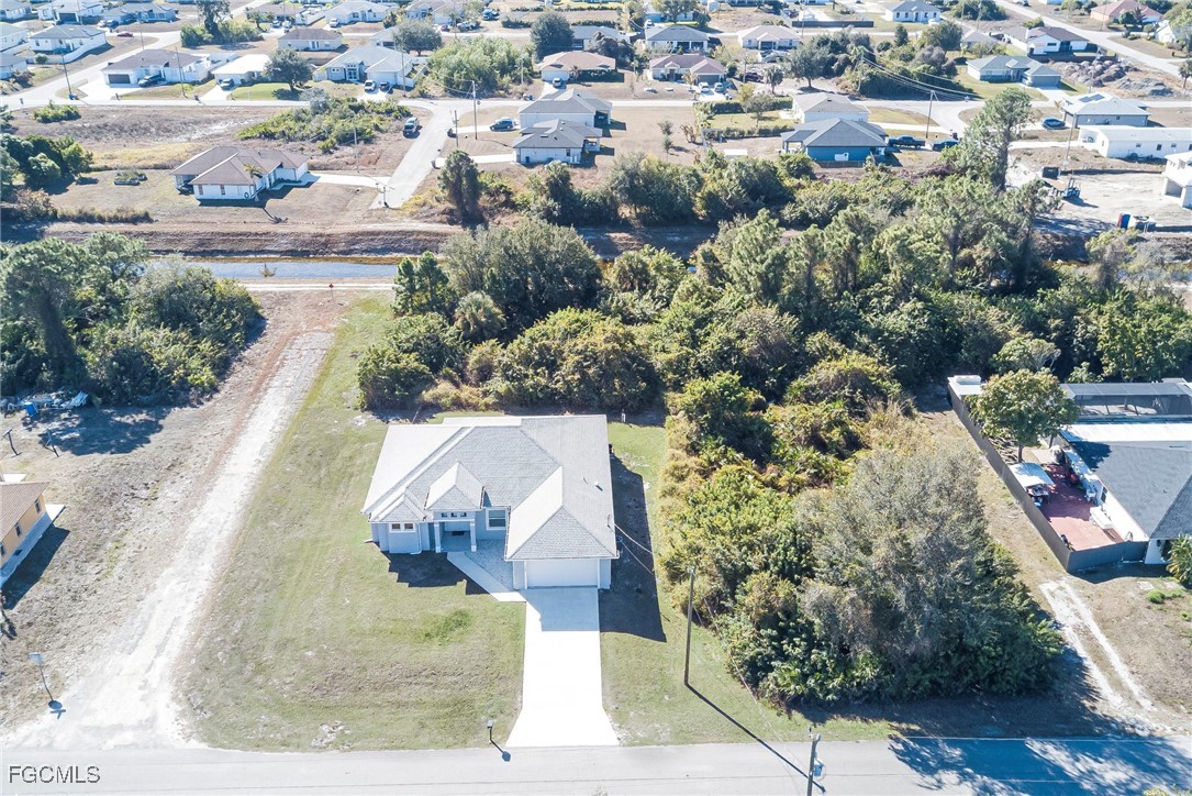 3309 30th Street Southwest Lehigh Acres, FL 33976 - Photo 28 of 28 an aerial view of a house with a yard