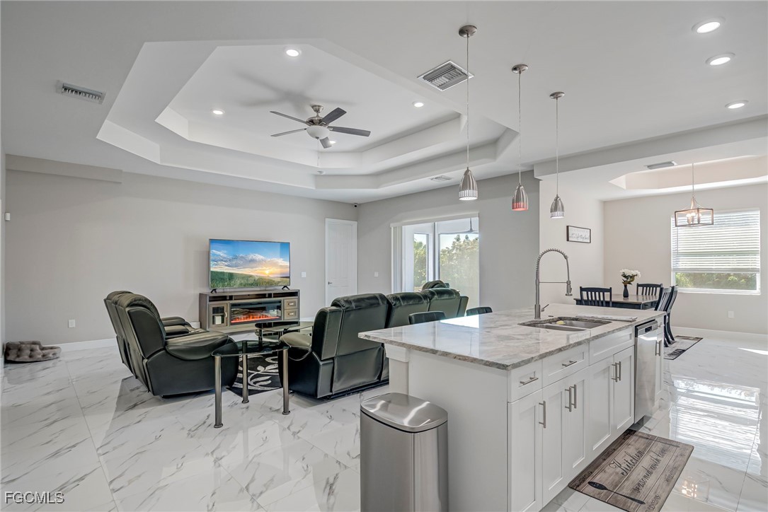 3309 30th Street Southwest Lehigh Acres, FL 33976 - Photo 5 of 28 a open kitchen with stainless steel appliances granite countertop a stove and a sink