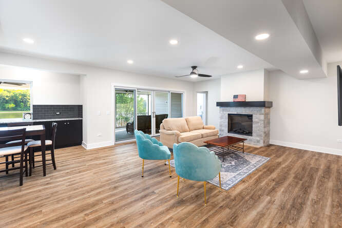 305 Leeward Way Ottawa, IL 61350 - Photo 43 of 53 a living room with furniture a fireplace and a dining table with wooden floor