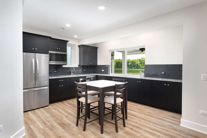 305 Leeward Way Ottawa, IL 61350 - Photo 45 of 53 a kitchen with a table chairs refrigerator and microwave
