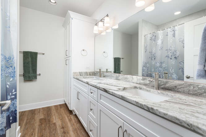 305 Leeward Way Ottawa, IL 61350 - Photo 48 of 53 a bathroom with a granite countertop sink a large mirror and a shower