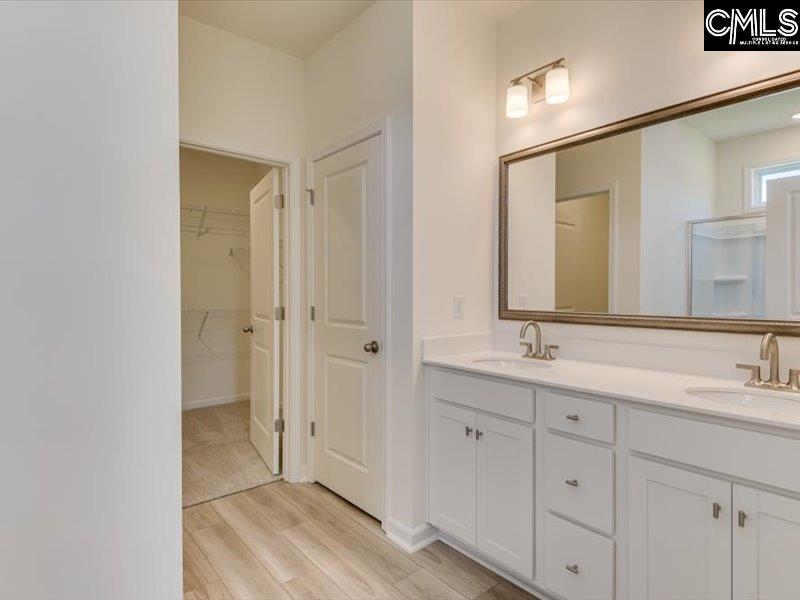 628 Old Charleston Road Pelion, SC 29123 - Photo 21 of 36 a bathroom with a double vanity sink and mirror