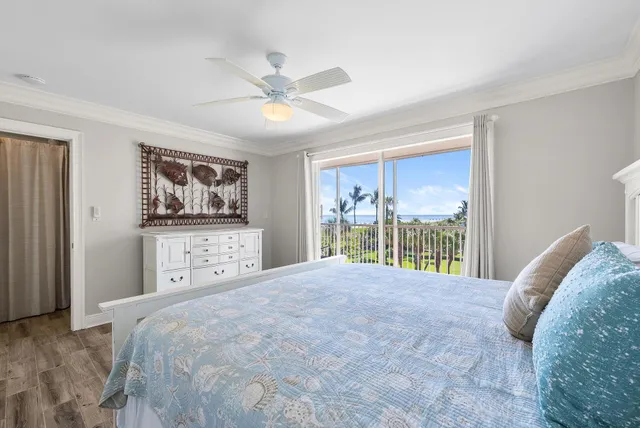 a large bed sitting in a bedroom next to a window