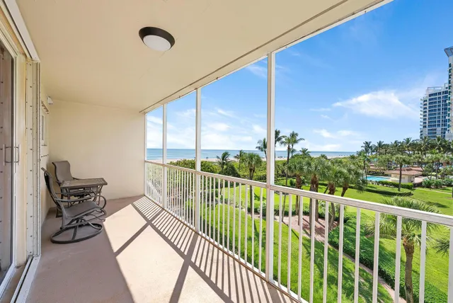a view of a chair and tables in the balcony