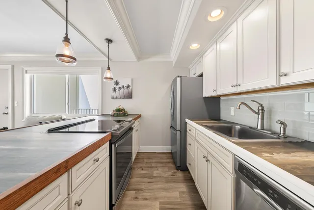 a kitchen with granite countertop a sink and dishwasher