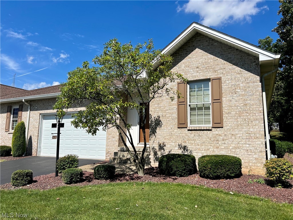 View of front facade featuring garage