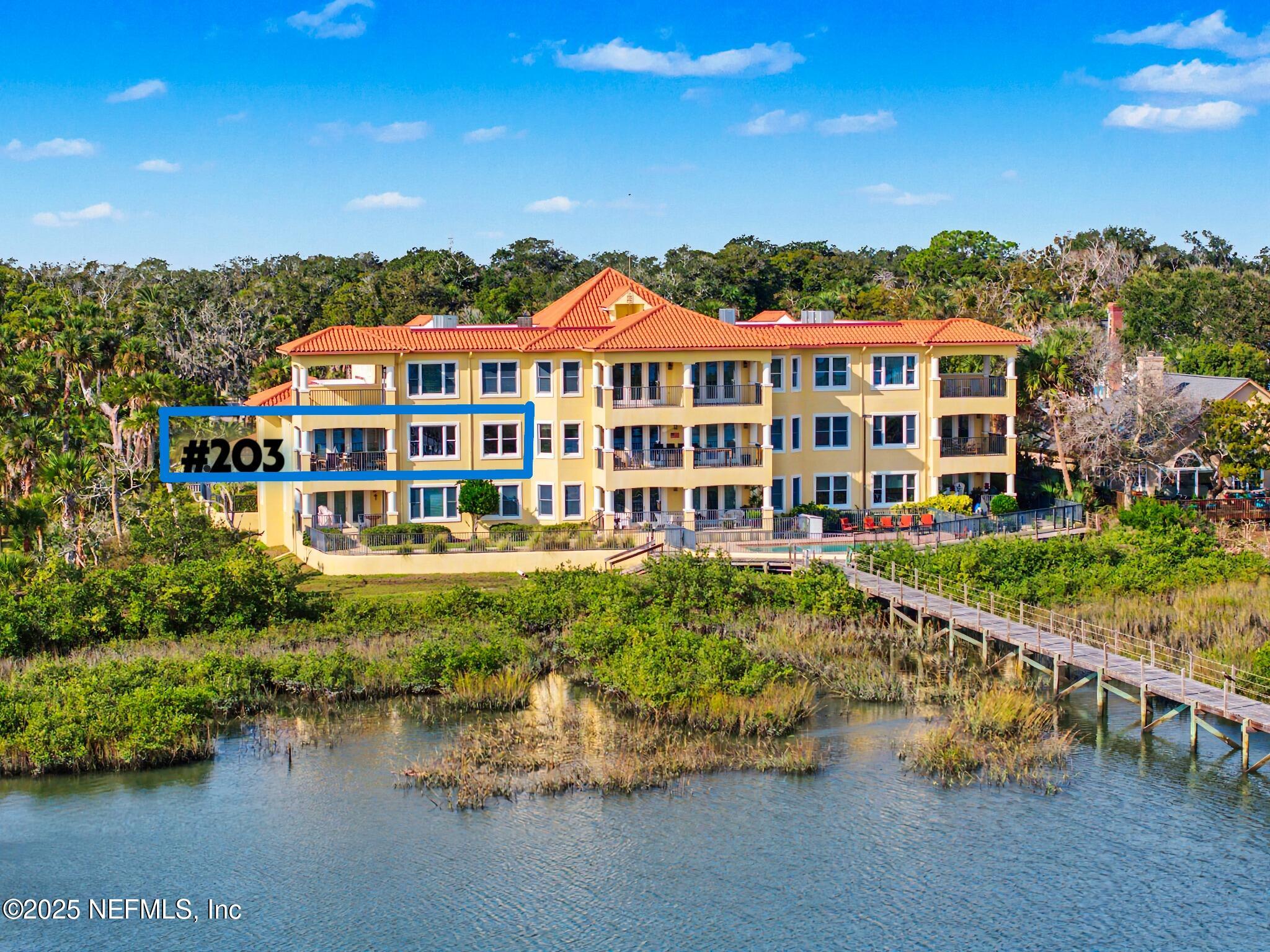 1 Radio Road, Unit 203 St. Augustine, FL 32084 - Photo 2 of 57 a front view of a house with a garden and lake view