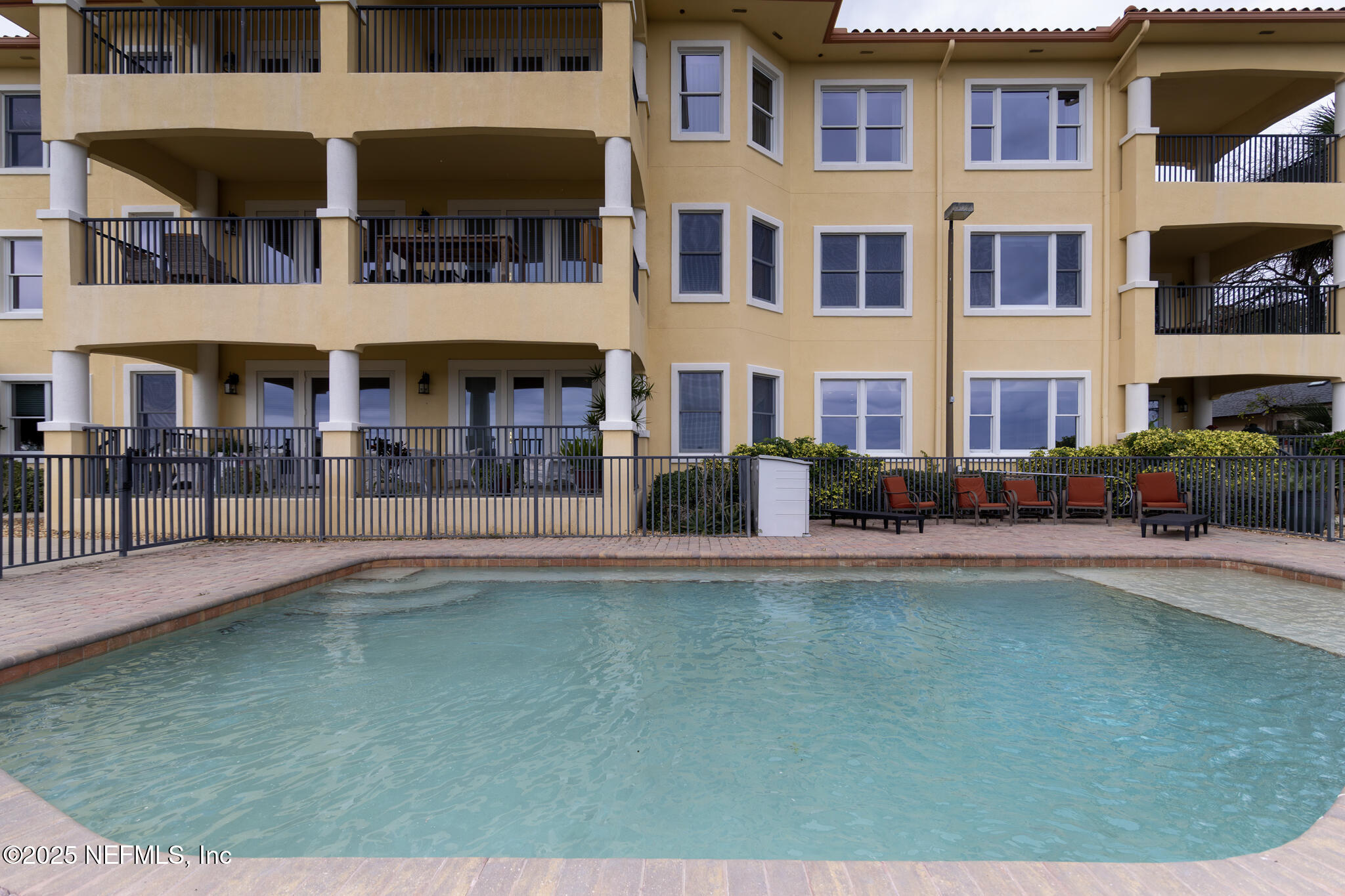 1 Radio Road, Unit 203 St. Augustine, FL 32084 - Photo 51 of 57 a front view of a building with a garden