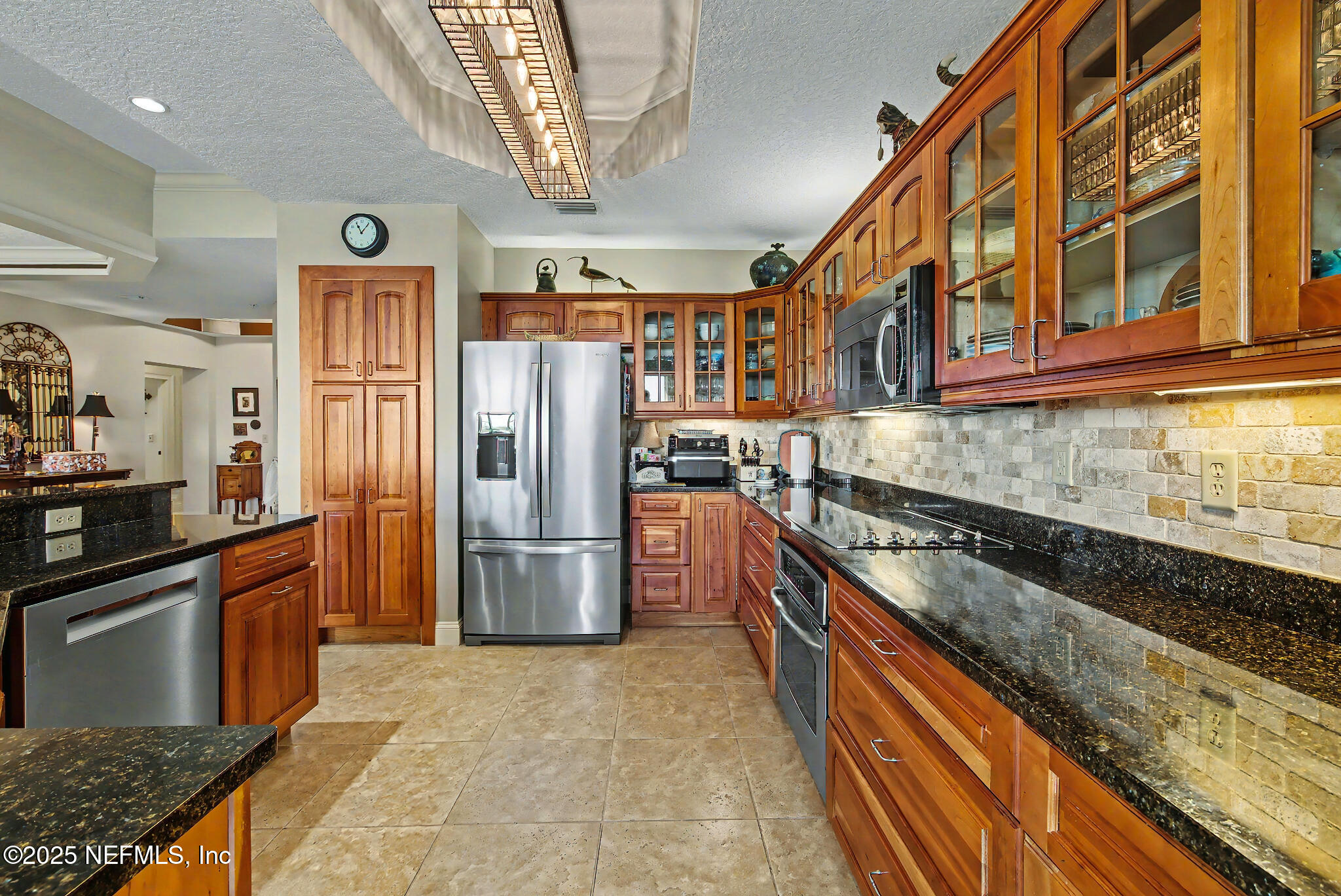 1 Radio Road, Unit 203 St. Augustine, FL 32084 - Photo 10 of 57 a kitchen with stainless steel appliances granite countertop a refrigerator a stove and a sink