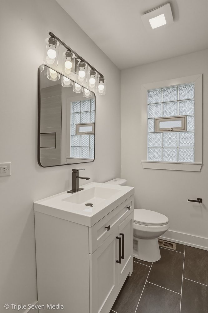 5831 81st Place Burbank, IL 60459 - Photo 20 of 31 a bathroom with a toilet sink and mirror