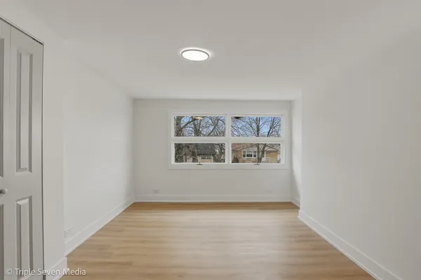 a bed room with a bed and a large window