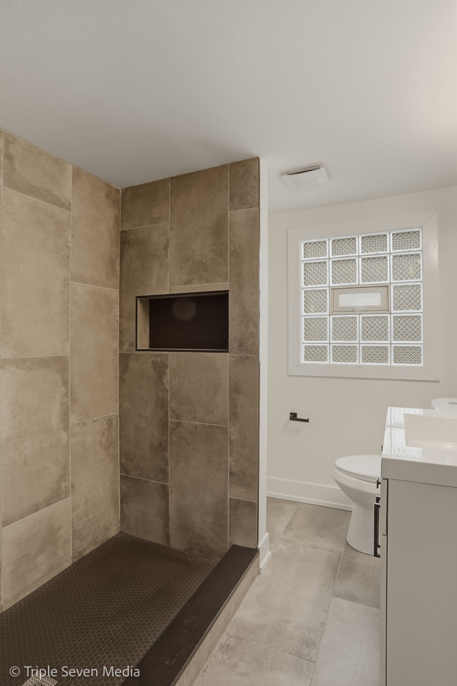5831 81st Place Burbank, IL 60459 - Photo 29 of 31 a bathroom with a granite countertop sink a toilet and shower