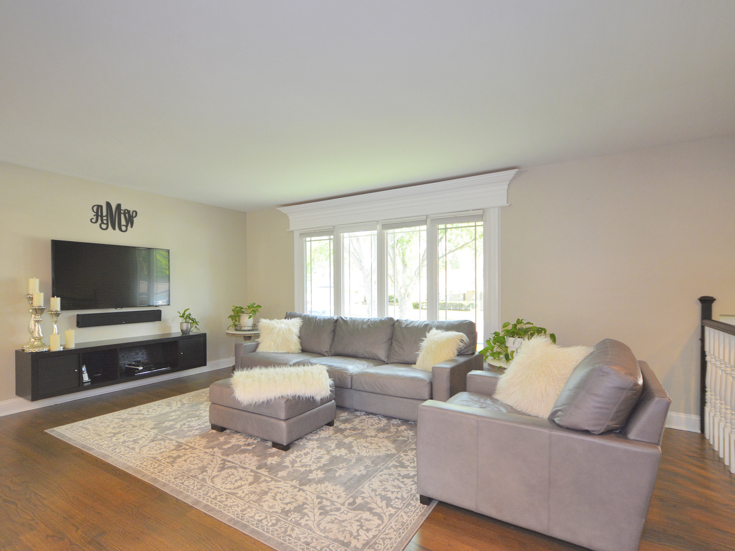 100 Ambleside Road Des Plaines, IL 60016 - Photo 2 of 15 a living room with furniture and a flat screen tv